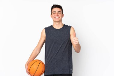 İzole edilmiş duvarda basketbol oynayan yakışıklı genç basketbolcu.