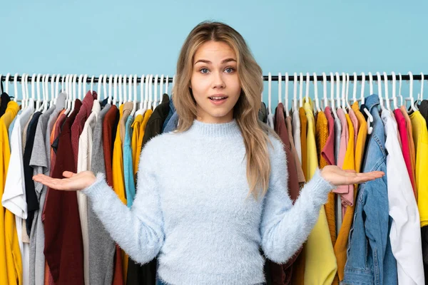 Teenager Russian Girl Buying Some Clothes Isolated Blue Background Shocked — Stock Fotó