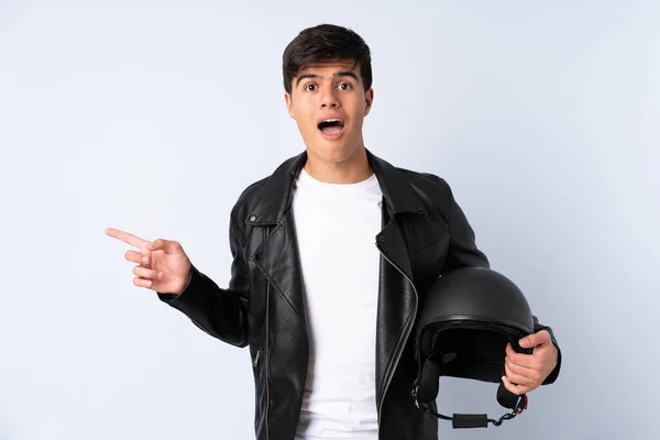 Man Motorcycle Helmet Isolated Blue Background Surprised Pointing Finger Side — Φωτογραφία Αρχείου