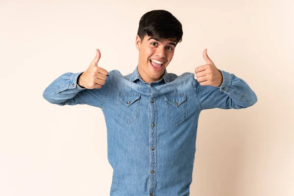 Handsome Man Isolated Beige Background Giving Thumbs Gesture — Stock Photo, Image