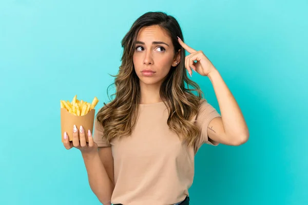 Junge Frau Mit Frittierten Chips Über Isoliertem Hintergrund Die Zweifel — Stockfoto
