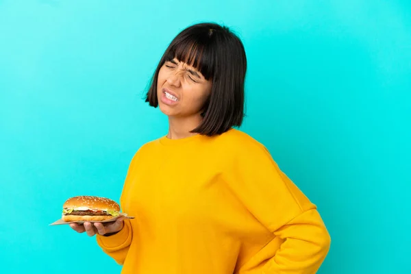 Young Brunette Woman Holding Burger Isolated Background Suffering Backache Having — Stock Photo, Image