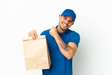 Brezilyalı, beyaz arka planda izole edilmiş bir paket yiyecek alarak zaferi kutluyor.