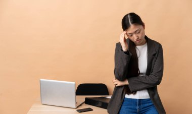 İş yerinde başı ağrıyan Çinli bir iş kadını.