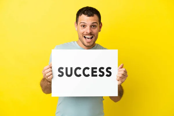 Brazilian Man Isolated Purple Background Holding Placard Text Success Surprised — Stock Photo, Image