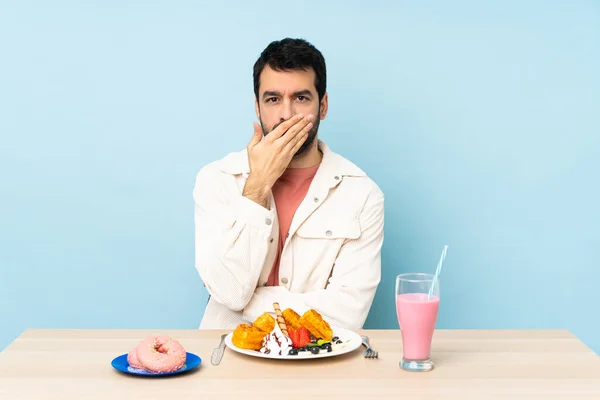Masada Kahvaltı Yapan Bir Adam Waffle Yiyor Ağzında Ellerle Milkshake — Stok fotoğraf