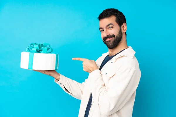 Young Handsome Man Big Cake Isolated Blue Background — Stock Photo, Image