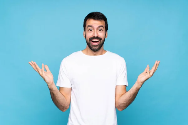 Jongeman Met Baard Geïsoleerde Blauwe Achtergrond Met Geschokte Gezichtsuitdrukking — Stockfoto