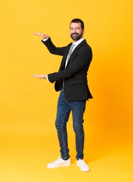 Full Length Shot Business Man Isolated Yellow Background Holding Copyspace — Stock Photo, Image