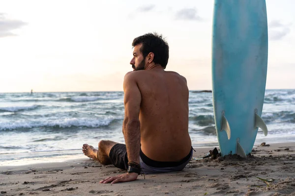 Young caucasian man get up early to  doing surf at sunrise