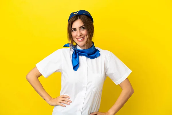 Airplane Stewardess Woman Isolated Yellow Background Posing Arms Hip Smiling — Stock Photo, Image