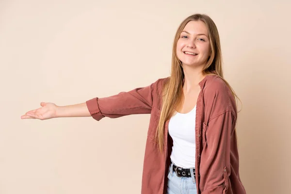 Teenager Ukrainian Girl Isolated Beige Background Extending Hands Side Inviting — Stock Photo, Image