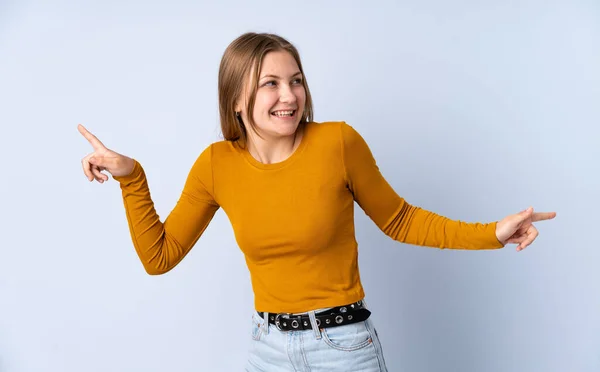 Teenager Ukrainian Girl Isolated Blue Background Pointing Finger Laterals Happy — Stock Photo, Image