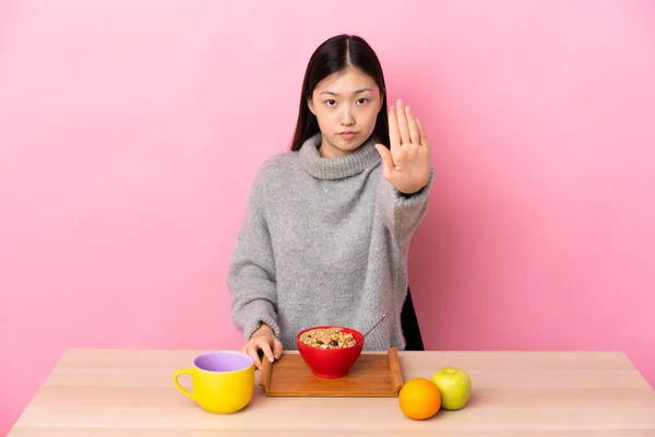 Młoda Chińska Dziewczyna Jedząc Śniadanie Stole Robi Gest Zatrzymania — Zdjęcie stockowe
