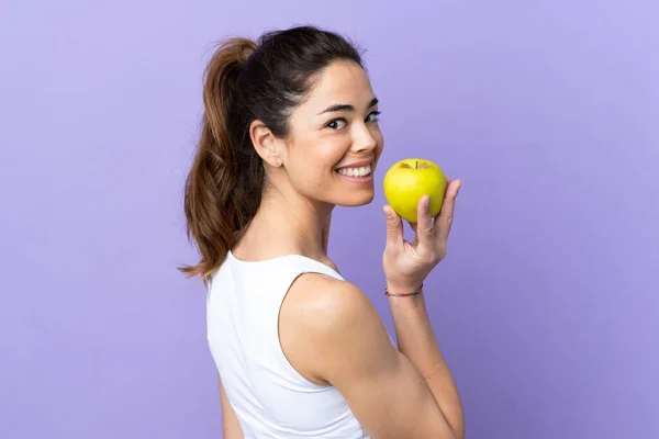 Woman Isolated Purple Background Eating Apple — ストック写真