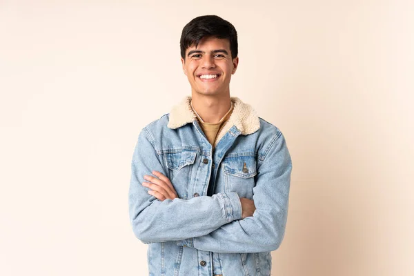 Handsome Man Isolated Beige Background Keeping Arms Crossed Frontal Position — Stock Photo, Image