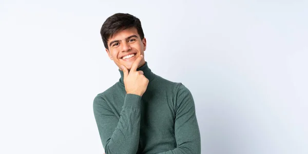 Yakışıklı Adam Soyutlanmış Mavi Arka Planda Mutlu Gülümsüyor — Stok fotoğraf