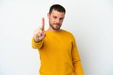 Beyaz arka planda izole edilmiş genç Brezilyalı adam parmağını kaldırıyor ve gösteriyor.