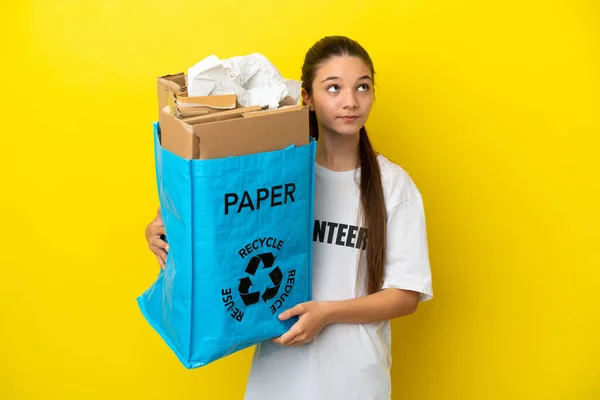 Little Girl Holding Recycling Bag Full Paper Recycle Isolated Yellow — Stock Photo, Image