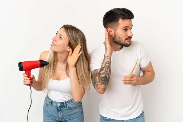 Couple Holding Hairdryer Brushing Teeth Isolated White Background Listening Something — Stock Photo, Image