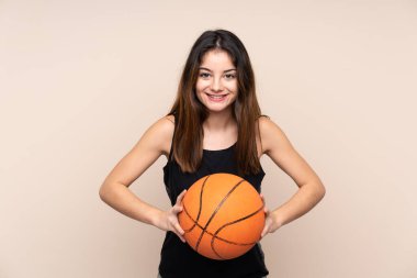 Beyazlı genç bir kadın, arka planda izole edilmiş basketbol oynuyor.