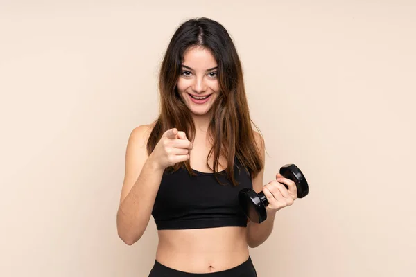 Young Sport Woman Making Weightlifting Isolated Beige Background Points Finger — Stock Photo, Image
