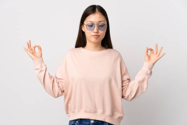 Zen pozisyonunda, izole edilmiş beyaz arka planı olan genç bir Çinli kız.