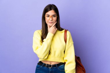 Mor arka planda kalan Brezilyalı genç kız bir fikir düşünüyor.