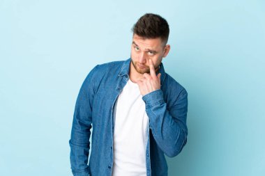 Mavi arka planda izole edilmiş Rus yakışıklı bir adam var.