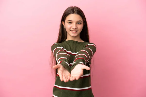 小さな女の子以上隔離されたピンクの背景を保持コピースペース想像上の上に手のひらに挿入する広告 — ストック写真