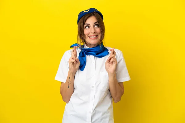 Airplane Stewardess Woman Isolated Yellow Background Fingers Crossing — Stock Photo, Image