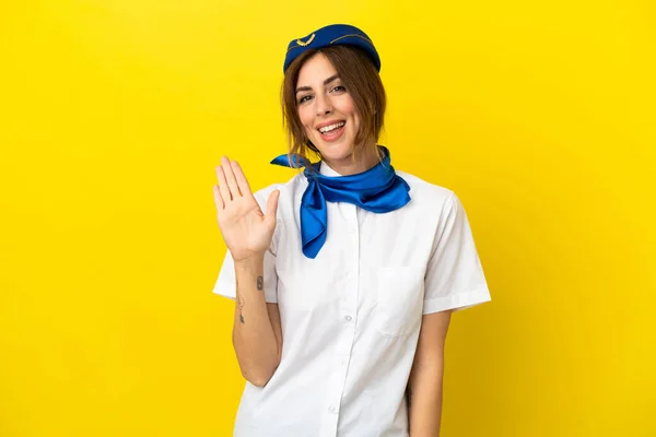 Airplane Stewardess Woman Isolated Yellow Background Saluting Hand Happy Expression — Stock Photo, Image