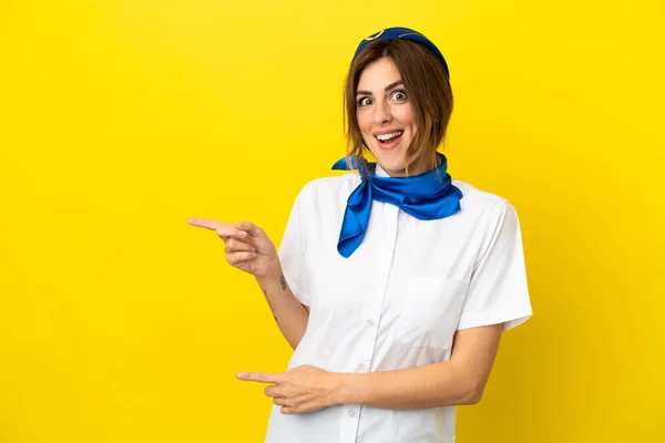 Airplane Stewardess Woman Isolated Yellow Background Surprised Pointing Side — Stock Photo, Image