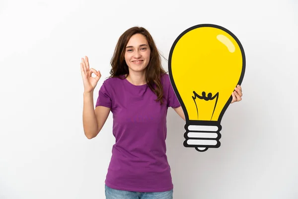 Young Caucasian Woman Isolated White Background Holding Bulb Icon Doing — Stock Photo, Image