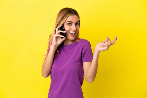 Young Woman Using Mobile Phone Isolated Yellow Background Extending Hands — Stock Photo, Image