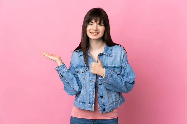 Young Ukrainian Woman Isolated Pink Background Holding Copyspace Imaginary Palm — Stock Photo, Image