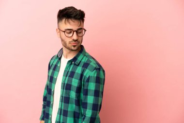 Pembe arka planda izole edilmiş genç beyaz bir adam. Portre