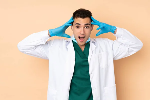 Young Dentist Man Holding Tools Isolated Beige Background Surprise Expression — Stock Photo, Image