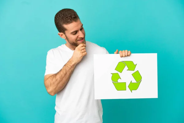 Handsome Blonde Man Isolated Blue Background Holding Placard Recycle Icon — Stock Photo, Image