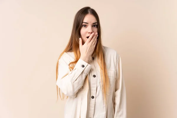 Young Caucasian Woman Isolated Beige Background Happy Smiling Covering Mouth — Stock Photo, Image
