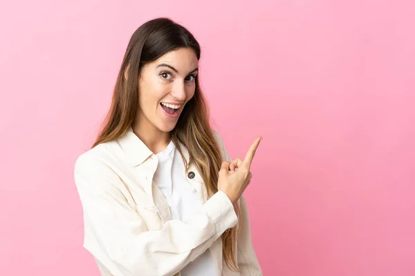 Giovane Donna Caucasica Isolata Sfondo Rosa Sorpreso Indicando Lato — Foto Stock