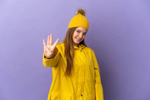 Menina Adolescente Vestindo Uma Capa Impermeável Sobre Fundo Roxo Isolado — Fotografia de Stock