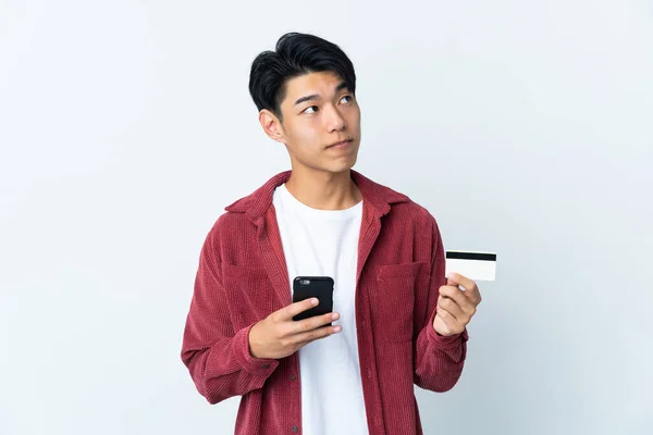 Fiatal Kínai Férfi Elszigetelt Fehér Háttér Vásárol Mobil Egy Hitelkártya — Stock Fotó