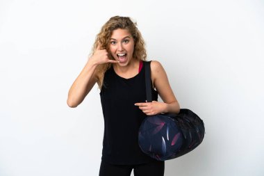 Spor çantalı genç bir kadın beyaz arka planda izole edilmiş bir şekilde telefon jesti yapıyor. Bana geri dönüş işareti ver.