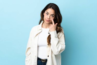 Woman over isolated background showing something