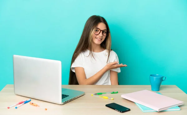 Menina Uma Mesa Com Laptop Sobre Fundo Azul Isolado Apresentando — Fotografia de Stock