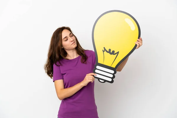 Young Caucasian Woman Isolated White Background Holding Bulb Icon Having — Stock Photo, Image