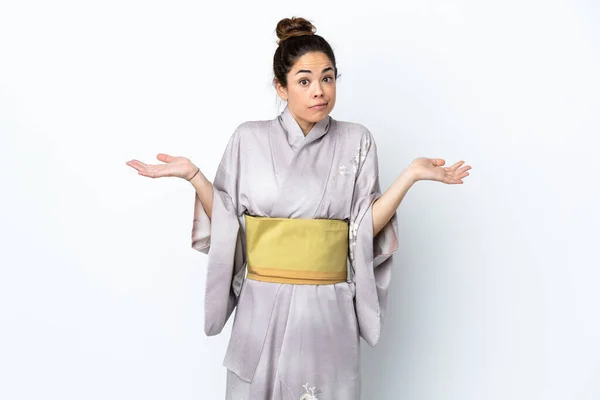 Woman Wearing Kimono Isolated Background Having Doubts While Raising Hands —  Fotos de Stock