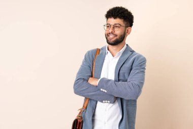 Young business Moroccan man isolated on beige background happy and smiling