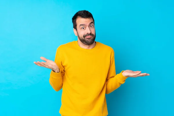 Young Caucasian Man Isolated Blue Background Making Doubts Gesture — Stock Photo, Image